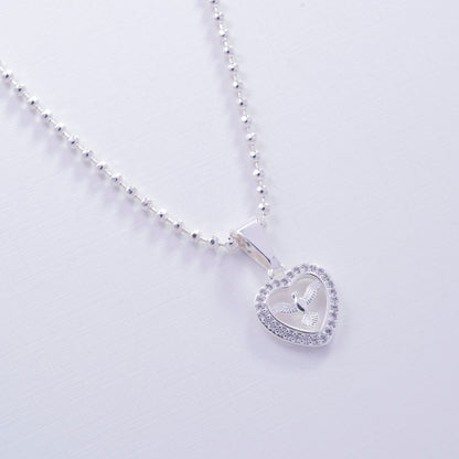 Dije cruz con corazón en Plata